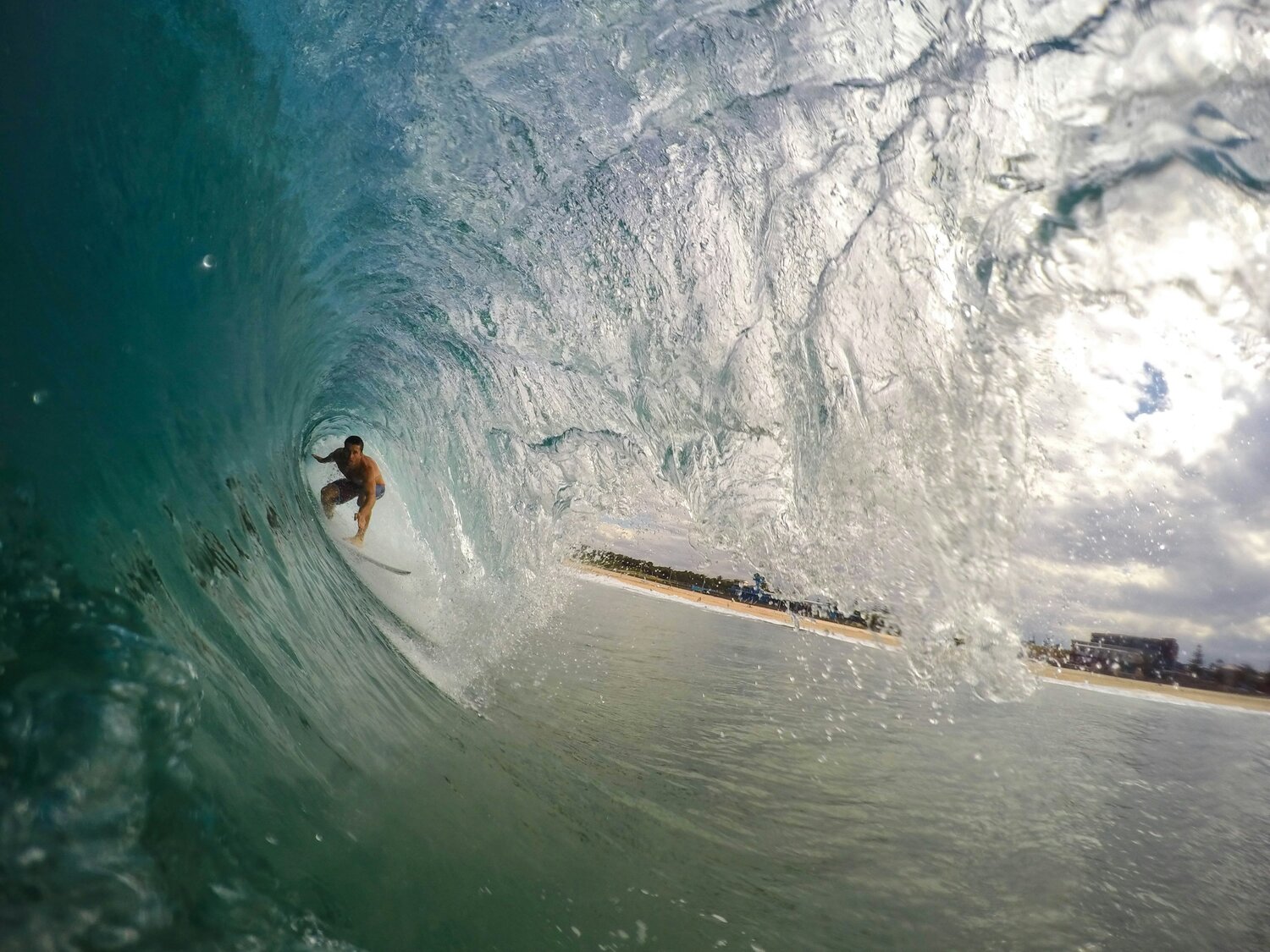 image-asset (7) a man riding a wave on a surfboard in the water